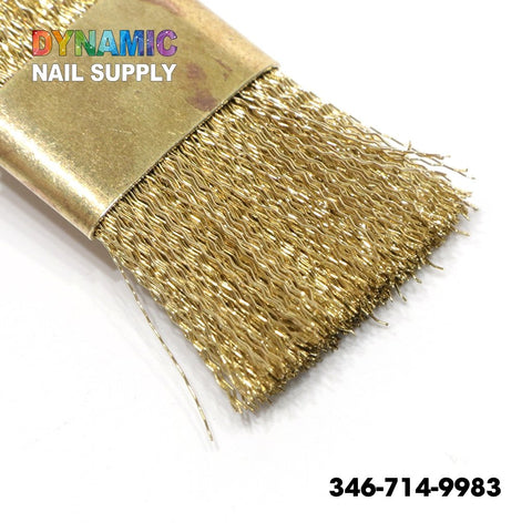A close-up of the QH0600 Copper Wire Brush from Dynamic Nail Supply reveals its dense, gold metallic bristles with a wavy pattern, partially enveloped by a shiny golden band. The brand name "Dynamic Nail Supply" is displayed in colorful letters at the top left corner. Ideal for cleaning tasks, the phone number 346-714-9983 is prominently featured in bold black on a white background in the lower right corner.