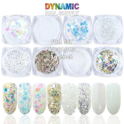 The QH15060 SET 18 Holographic Nail Art Glitter Set Powder by Dynamic Nail Supply is showcased with eight small jars, each containing a unique glitter: holographic pastel stars, white powder, silver sequins, iridescent effects, a multicolored mix, gold mix, rainbow circles, and translucent white. Swatches below highlight the dazzling effects of each nail art creation.