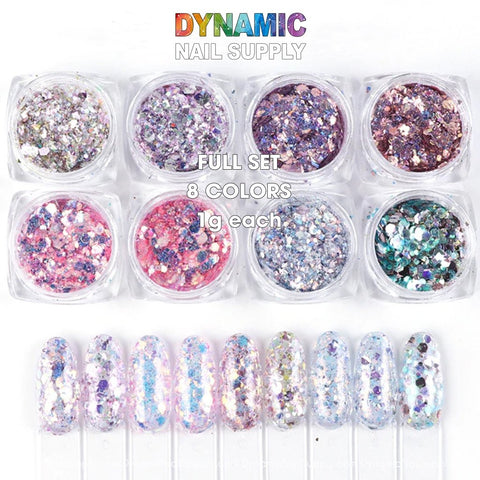 Image showcasing the QH15060 SET 19 Holographic Nail Art Glitter Set Powder by Dynamic Nail Supply, featuring eight small containers of diverse color blends with glittering particles. Below, eight nail tips illustrate how the glitter looks over a clear base, highlighting the set's vibrant colors.