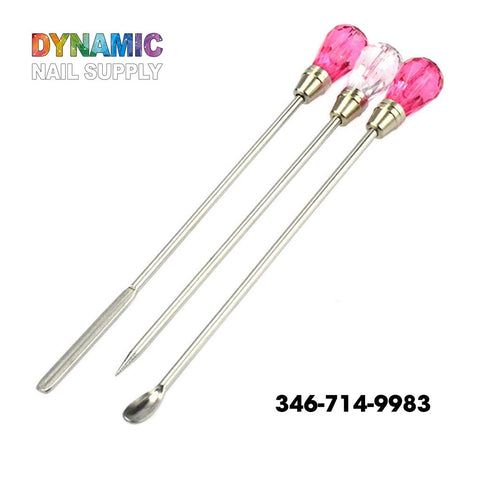 Introducing the QH3200 Nail Art Stirring Rod Tools from Dynamic Nail Supply, featuring three metal nail tools with elegant pink crystal-like handles. Each tool is designed for precision in nail art and includes a stainless steel spatula, a pointed end, and a spoon-shaped tip. The brand's vibrant logo is prominently displayed at the top left corner, while the contact number 346-714-9983 can be found at the bottom right.