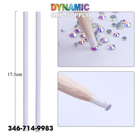 The image showcases the QHTR360 Wooden Nail Dotting Pencils by Dynamic Nail Supply, designed for rhinestone crystal gem nail art decoration. On the left are two 17.5 cm long white stylus tools, and to the right is a detailed view of a wooden-tipped tool picking up an iridescent rhinestone crystal gem. The brand name "Dynamic Nail Supply" is prominently displayed at the top in colorful letters, along with a contact number below.