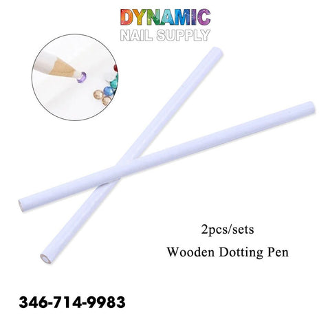 The image features two white wooden nail dotting pencils from the QHTR360 series, arranged in an X shape against a plain background. In the top left corner, there is a circular inset illustrating one pen tip applying purple polish to rhinestone crystal gems. The text reads Dynamic Nail Supply and highlights the set of 2pcs Wooden Dotting Pen.