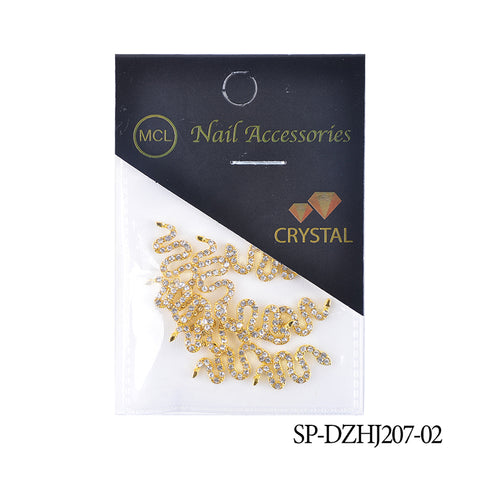 A clear plastic package houses snake-shaped nail charms in a gold and rhinestone design, ideal for enhancing any nail art. The black top features the Dynamic Nail Supply logo in gold. Locate product code SP-DZHJ207-02 on the corner, available at Dynamic Nail Supply.
