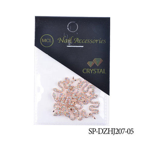 A package of MCL crystal nail accessories, labeled as 10 pcs of Snake Shape Charms for Nails Art Design (Smaller version) from Dynamic Nail Supply, features a black top with branding and a triangular transparent section revealing coiled snake-shaped charms embellished with rhinestones. The product code SP-DZHJ207-05 is printed in the bottom right corner.
