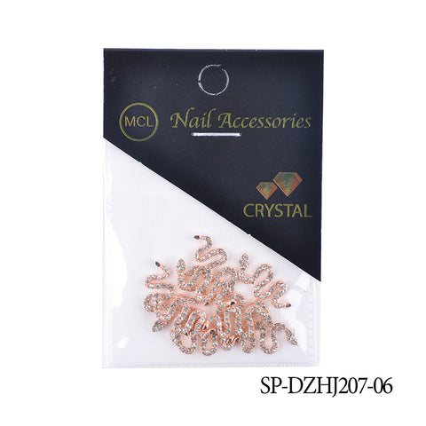 The packaging for the Dynamic Nail Supply Nail Accessories is a small plastic bag containing rose gold snake-shaped embellishments and Snake Shape Charms with small crystals. The label displays a gold Dynamic Nail Supply logo, "Nail Accessories" text, and a crystal graphic. The product code SP-DZHJ207-06 appears at the bottom right corner.