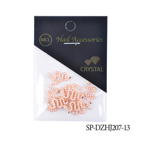 A pack of 10 Snake Shape Charms for Nail Art Design (Smaller version) is perfect for enthusiasts of Dynamic Nail Supply. The transparent packaging, adorned with peach-colored wavy patterns and a green and orange crystal motif logo, includes the product code SP-DZHJ207-13 at the bottom right.