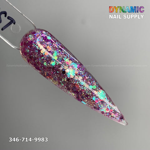 A swatch of Amethyst #333 from Dynamic Nail Supply features a long almond-shaped acrylic nail coated with pink, non-toxic glitter powder that sparkles in shades of blue, green, and gold. The image also displays the contact number 346-714-9983.