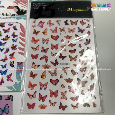 A sheet of Butterfly Stickers for Nails Art Design is displayed, offering a delightful blend of pink, red, and orange in various sizes and styles. Perfect for enhancing your nail design, the Dynamic Nail Supply packaging sits poised on a reflective surface alongside other sticker sheets.