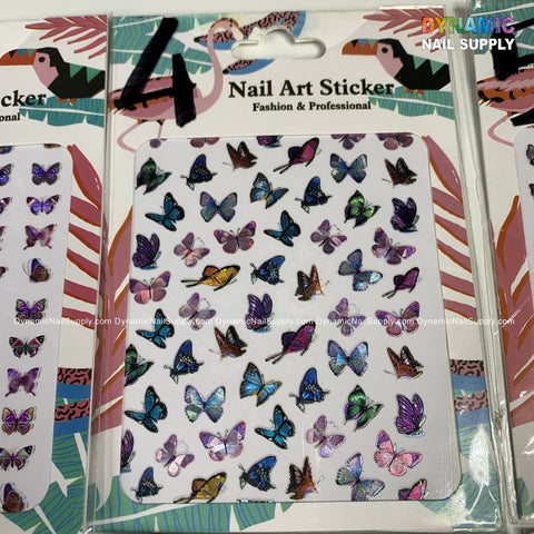 The Butterfly Stickers for Nails Art Design by Dynamic Nail Supply boast a breathtaking collection of design choices. Featuring vibrant butterflies in purple, blue, and pink hues with various sizes and styles, they are packaged under the Dynamic Nail Supply logo against a tropical leaf background—ideal for creative nail artistry.