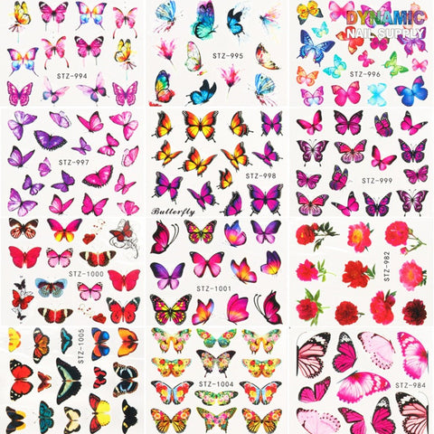 A collage of nail stickers features Dynamic Nail Supply's 24 sheets of Butterfly Water Decals, each square brimming with vibrant styles and colors—pink, orange, blue, and multi-colored butterflies. Designer elements include floral and rose motifs. The dynamic top right corner showcases their 3D nail art collection.