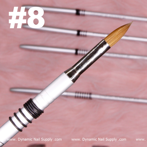 A close-up of a Dynamic® High-quality 3D Brush from Dynamic Nail Supply is shown, featuring its pointed brown Kolinsky hair bristle tip, a sleek white handle, and a silver ferrule. In the background, four additional professional brushes create a blurred effect on a soft pink surface. Bold white text displaying number #8 is visible in the top left corner.