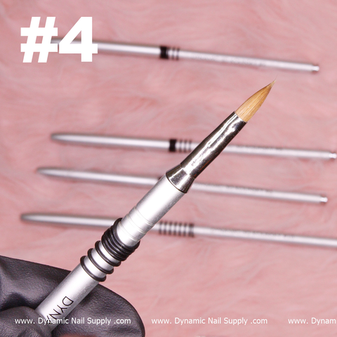 A close-up of a silver Dynamic® High-quality 3D Brush, crafted with Kolinsky hair and featuring a fine, pointed tip, is held by a gloved hand. In the background, four similar brushes are laid out on a soft, pink furry surface. The white text "#4" appears in the top left corner and "www.DynamicNailSupply.com" is repeated at the bottom.