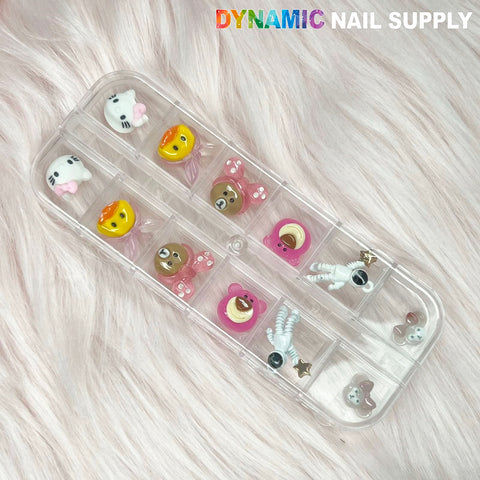 Cartoon Characters Nail Charms set 02: clear nail charms with cartoon designs on a fluffy pink background.