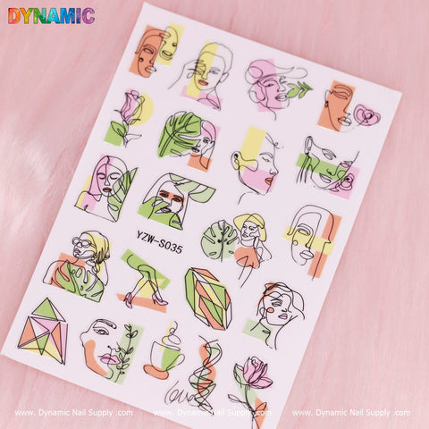 A sheet of the Hand Writing nail stickers, labeled YZW S035, is set against a light pink background. The designs feature stylized line drawings of faces, plants, and geometric shapes in vibrant green, orange, purple, and pink hues. The Dynamic Nail Supply brand is prominently displayed at both the top and bottom.