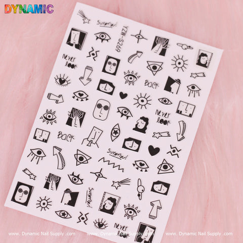 The Evil Eyes and Spirit styles (Black and White) nail art stickers from Dynamic Nail Supply, also known as YZW S269, are set against a pink background. They showcase a captivating array of abstract faces, eyes, suns, lightning bolts, and words such as "summer!" and "back." The designs incorporate a diverse blend of minimalist geometric shapes, organic forms, and intriguing spirit styles.