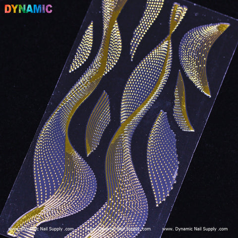 A close-up of the Gold dot and swirl pattern (FL 2020) from Dynamic Nail Supply highlights intricate gold nail art decals with swirling designs that resemble leaves or flames, crafted from tiny dots and lines. The metallic swirl pattern is accentuated by the black background, with the Dynamic Nail Supply branding prominently displayed in the top left corner.