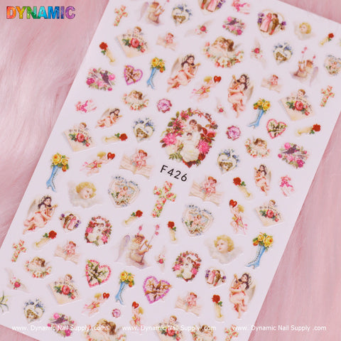 The "Angel, Cupid, Holy and Christian style (F426)" nail stickers from Dynamic Nail Supply feature cherubs, cupid figures, floral wreaths, roses, and gift motifs in pastel shades. These vibrant and intricate designs are set against a white background with the F426 label at the center, making them ideal for creating decorative manicure designs with a touch of Christian style.