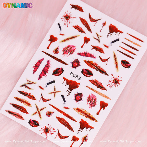 The Bloody Halloween Sticker from Dynamic Nail Supply showcases eerie designs such as dripping blood, bloody knives, fangs, and scars in dark red and black against a pink background. The word "DYNAMIC" is prominently displayed in rainbow colors at the top-left corner, with the code B089 boldly positioned at the center.