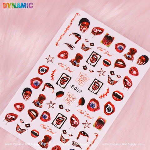 A sheet of Dynamic Nail Supply's Bloody Halloween Stickers (B087) on a pink background showcases red and black horror-themed designs, perfect for Halloween. Adorned with eyes, lips, and teeth, it includes text like VCK ART and Oh My God, featuring a truly captivating bloody sticker collection.