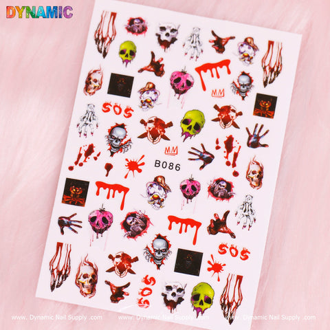 A sheet of Halloween-themed nail art stickers from Dynamic Nail Supply, featuring the B086 decals on a pink background. These stickers include skulls, hands, blood drips, and SOS text in red, along with creepy faces, bleeding eyeballs, and an array of spooky motifs in vibrant colors such as red, green, and black.