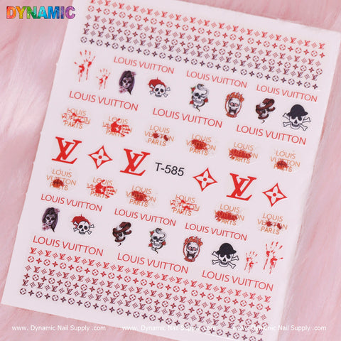 A sheet of Luxury Halloween Stickers (T-585) by Dynamic Nail Supply showcases an assortment of Louis Vuitton logos, skull designs, and face illustrations on a pink background. These striking red and black decals are ideal for Halloween. The top is labeled DYNAMIC, with Dynamic Nail Supply printed in white text at the bottom.