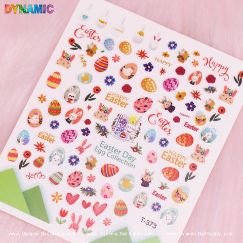 The Happy Easter Sticker (T-373) by Dynamic Nail Supply is displayed against a pink background. It features vibrant designs, including colorful eggs, bunnies, and flowers. Phrases such as "Happy Easter" and "Easter Day Egg Collection" enhance its festive charm, making it perfect for cheerful nail art.