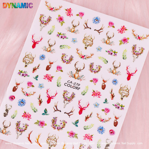 Explore the captivating Deer Sticker (CA 270) by Dynamic Nail Supply, featuring lively deer heads embellished with flowers, antlers, and foliage. This vibrant sticker sheet includes colorful designs with roses and blue and purple blooms set against a soft pink background, making it an enchanting addition to any collection.