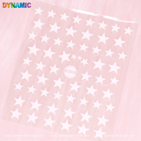 A sheet of White Star Sticker (DP3209) is showcased against a light pink background. The vibrant word "DYNAMIC" appears in the top left corner, while "Dynamic Nail Supply" is printed along the bottom edge. At the center, a circular logo featuring DP3240 complements the sticker designs such as DP3209.