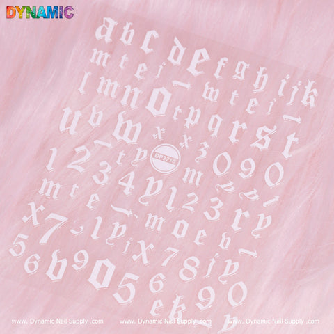 A pink sheet featuring scattered white Gothic-style letter and number stickers, including both lowercase and uppercase characters, as well as digits. At the center is a round logo with the product code "DP3216." The background is a soft pink with a subtle texture, branded by Dynamic Nail Supply.