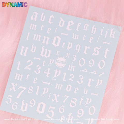 A pink background displays a sheet filled with white Gothic-style letters and numbers, featuring the entire alphabet from a-z, digits 0-9, and symbols such as a heart and star. At its center is an oval logo with the product name "Letter and Number Sticker (DP3216)." The brand name "Dynamic Nail Supply" is repeated at the bottom, making it ideal for your upcoming Letter Sticker project.