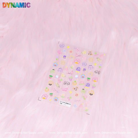 A sheet of Colorful Kid Hand Drawing Stickers (TS-1249) from Dynamic Nail Supply lies on a fluffy pink background. With adorable designs such as animals, fruit, and hearts in vibrant pastels, these stickers exude a charming vibe. The soft texture contrasts with the delicate artwork, while the Dynamic logo prominently features.