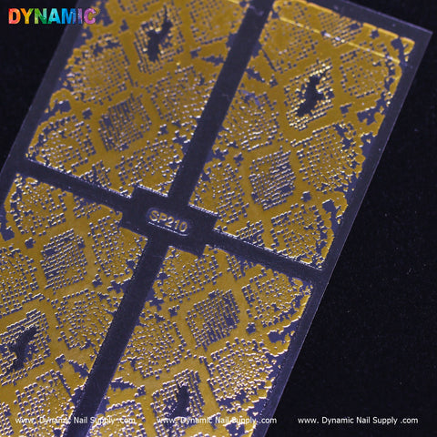A close-up of the Animal Pattern Nail Sticker (SP210) reveals intricate gold snake designs on a clear, glossy sheet. The dark background enhances the shimmer of this pattern, and "Dynamic Nail Supply" is printed along the bottom edge, emphasizing its quality as a premium nail sticker.