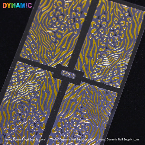 Close-up of a metallic nail art stamping plate featuring vibrant animal patterns. Divided into four sections, it showcases flowing zebra and leopard motifs. A small rectangular label in the center reads Animal Pattern Nail Sticker (SP218), with the brand name Dynamic Nail Supply elegantly displayed at the top.