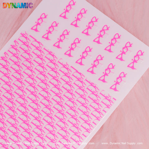 The Luxury Water Decal in neon pink from Dynamic Nail Supply features elegant rows of bows and ribbons. Larger designs adorn the top row, with smaller ones completing the rest of the sheet. The vivid background enhances its luxurious appeal, while "Dynamic Nail Supply" is printed at the bottom edge for a touch of sophistication.