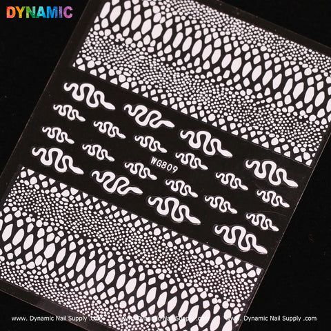 The black nail art sticker sheet, featuring Dynamic Nail Supply's Snake Skin Nail Water Decal (WG809) - White, highlights various white snake and reptile scale patterns. It includes wavy snake designs at the center, labeled WG809, complemented by textured scale motifs. The alluring snake skin details are enhanced by the DYNAMIC logo in vibrant colors displayed at the top left corner.