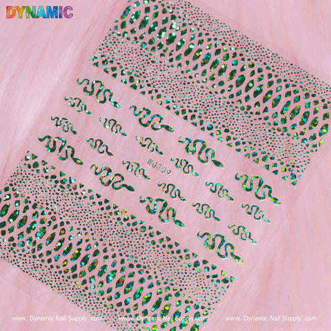 The Snake Skin Nail Water Decal (WG809) from Dynamic Nail Supply showcases a green holographic design with wavy, dot, and curvy line patterns in eye-catching green and silver shades against a sophisticated soft pink background. The brand's logos are prominently featured at the top and bottom of the image.