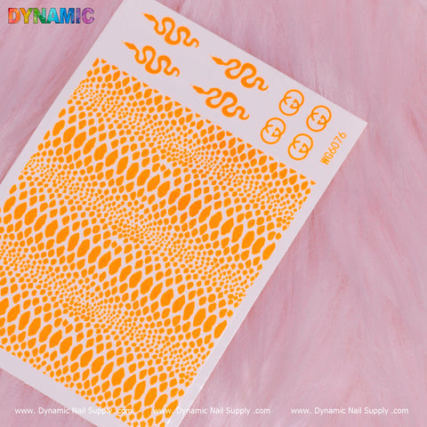 A Snake Skin Nail Water Decal in neon orange, featuring a vibrant combination of snakeskin patterns and wavy, flame-like designs, is displayed on a textured pink surface. The collection includes an assortment of small circles and serpentine curves. "Dynamic Nail Supply" is prominently printed at the bottom, highlighting their distinctive water decal series.