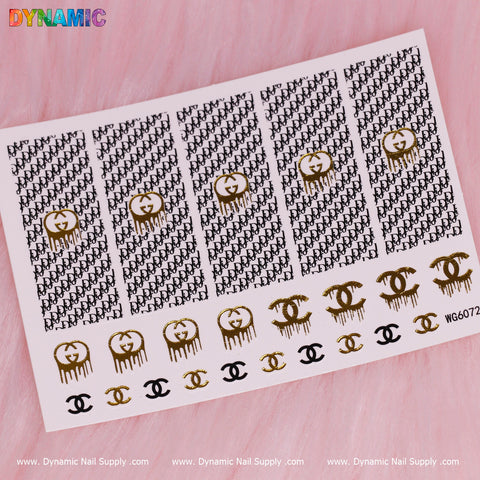 A sheet of the Luxury Style Water Decal (WG6072) by Dynamic Nail Supply is displayed on a pink background, featuring alternating designs of black initials and gold dripping smiley faces. The bottom row contains gold and black Chanel logo stickers, with "WG6072" in rainbow colors at the top left and product details at the bottom.