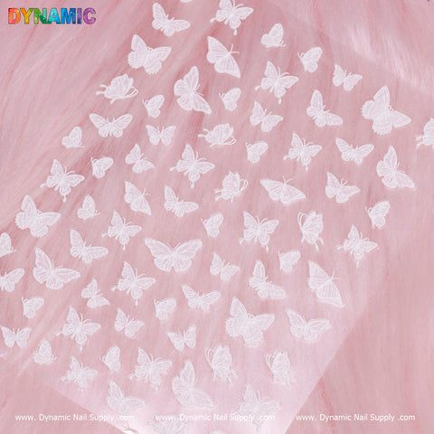 Sheer pink nails with White Butterfly Sticker, DYNAMIC logo, and website at the edges.