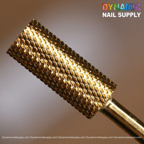 Close-up of a gold-colored, cylindrical nail drill bit featuring a crosshatched texture for surface smoothing. Crafted from durable tungsten carbide, it stands against a soft gray background. The name "Dynamic Nail Supply" appears in colorful text at the top, accompanied by the URL at the bottom edge in white text. This is the Fine (F) Small Barrel - Easy and Safe to Use for Smoothing Acrylic from Dynamic Nail Supply.