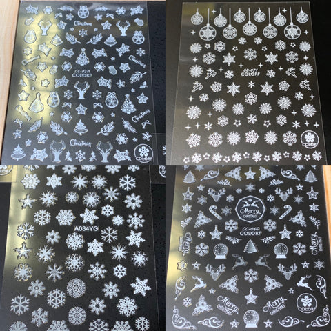 Celebrate the holiday season with Dynamic Nail Supply's "Bundle of 20pcs Christmas Nail Stickers" for $30. This festive collection includes four sheets of silver decals featuring detailed designs such as snowflakes, ornaments, trees, reindeer, Santa Claus, and snowmen on an eye-catching black background, perfect for adding some holiday cheer to your nails.
