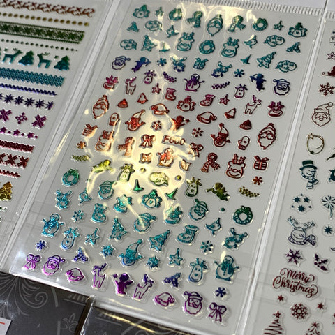 This Bundle of 20pcs Christmas Nail Stickers for $30 by Dynamic Nail Supply features a collection of vibrant, Christmas-themed designs, including charming reindeer, Santa faces, Christmas trees, snowflakes, stockings, and bells. Arranged neatly in rows, the stickers shimmer in metallic red, green, blue, and other festive hues.