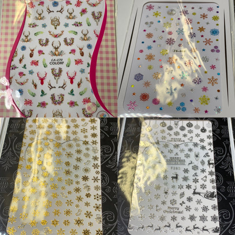 A set of 20 pieces of Christmas nail stickers from Dynamic Nail Supply, priced at $30, is displayed. The top left sheet showcases vibrant floral and animal patterns, the top right contains various multicolored snowflakes, the bottom left sheet exhibits gold snowflakes, and the bottom right features silver snowflakes with "Merry Christmas" text.