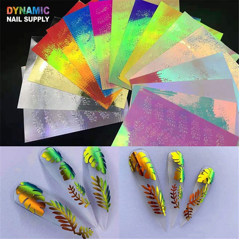 The "Hot Design 16pcs/set - Holographic Leaves Sticker for Nail Art Decoration" by Dynamic Nail Supply showcases a variety of nail decoration foils with holographic leaf patterns in multiple colors. Below are several nails demonstrating the application of these foils, featuring reflective designs in gold, orange, and green. The Dynamic Nail Supply logo is positioned in the upper left corner.