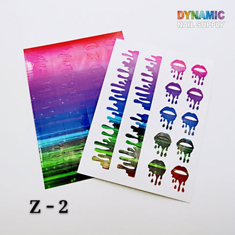The Hot Designs - Lips Sticker for Nails Art Decoration by Dynamic Nail Supply features a vibrant sheet with lips sticker designs, dripping paint motifs, and parallel stripe cutouts in various shades. A sample of multicolor gradients is shown below the design. The top right corner displays the brand name Dynamic Nail Supply, and the decorative code Z-2 is located in the bottom left corner.