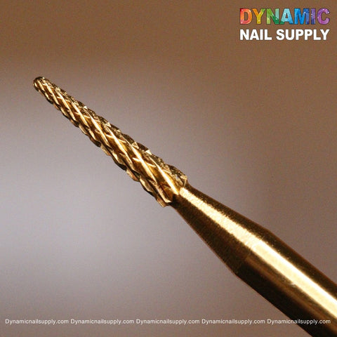 Close-up of the Medium Sharp Point Bit - Dynamic Drill Bit in a gold color, specifically crafted for sealing the cuticle area with its textured, ridged surface. The background is softly blurred, while the top right corner showcases the dynamic logo of Dynamic Nail Supply in vibrant text.