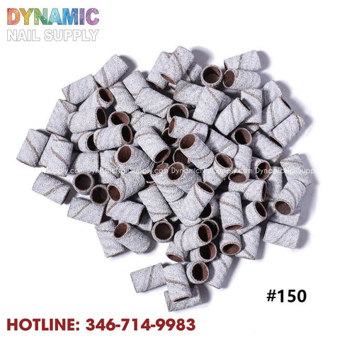 A collection of Machine Nail Drill Bits Zebra Sanding Bands—essential manicure tools with a sandpaper texture for precise nail work—is displayed beneath the vibrant Dynamic Nail Supply branding. In the bottom corner, the number #150 is shown alongside the hotline 346-714-9983 in bold red text.