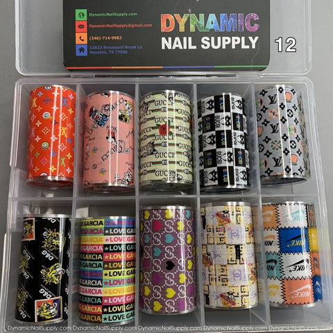 The Nail Art Design Foils - 12 from Dynamic Nail Supply come in a clear plastic box containing 12 rolls of vibrant nail foils. Each roll presents unique nail art designs, featuring brand-inspired patterns such as logos, floral motifs, and geometric shapes. The packaging also provides store contact details for further inquiries.