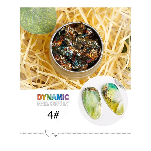 A tin container highlights the Big Size 14cm Nail Foil paper for nail art design from Dynamic Nail Supply, showcasing vibrant metallic foils elegantly nestled on straw. Below, two oval nail tips display a stunning green and gold marbled pattern with touches of orange. The bold text "DYNAMIC NAIL SUPPLY" and "4#" are prominently featured, with a decorative swirl underneath, complementing the Dynamic Nails System series aesthetic.