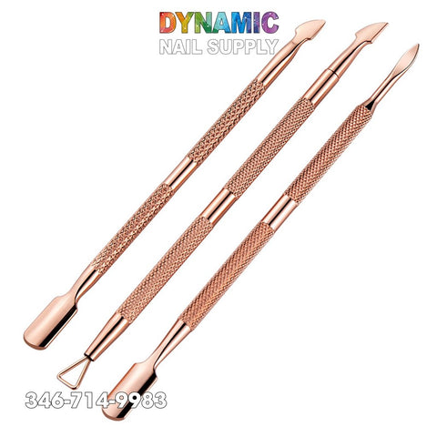 Three dual-ended rose gold nail tools from Dynamic Nail Supply are showcased against a white backdrop. These stainless steel tools feature a variety of shapes on each end for optimal cuticle grooming precision. The background includes the Dynamic Nail Supply logo and contact number, 346-714-9983, ideal for your rose gold nail art needs.
